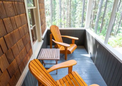 Adirondack deck chairs on cabin patio at Johnston Canyon Lodge and Bungalows in Banff National Park