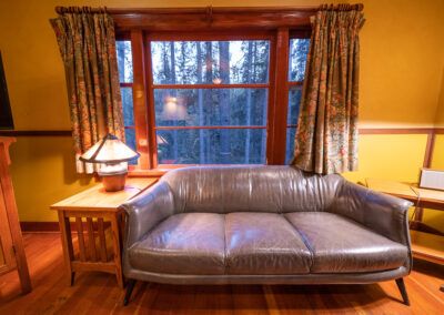 Cabin living room and forest view at Johnston Canyon Lodge and Bungalows in Banff National Park