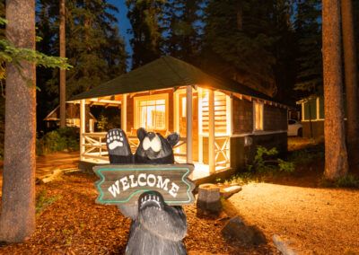 Bear welcome statue and Cabin at Johnston Canyon in Banff National Parks at night